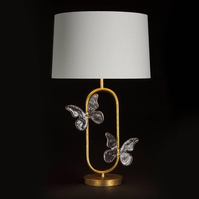 The Monarch's delicate looking steel frame dusted in a light gold leaf finish is set set off by two clear glass...