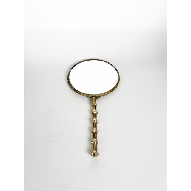 Elegant French hand mirror crafted from solid brass, featuring a classic double-sided design with a finely detailed beaded...