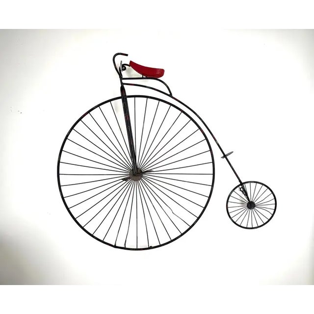 This Curtis Jere High Wheel Bicycle Iron Sculpture is an exquisite blend of artistry and nostalgia, capturing the essence...