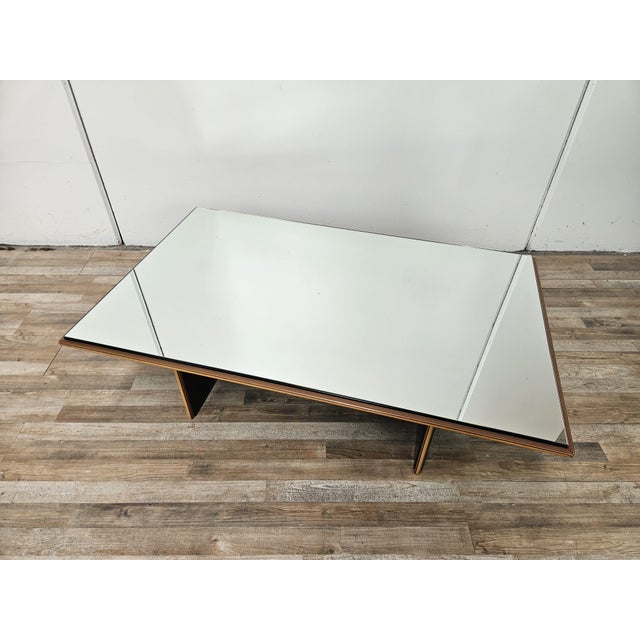 An elegant Italian coffee table from the 1960s, characterized by a simple, architectural geometry, clearly echoing the...