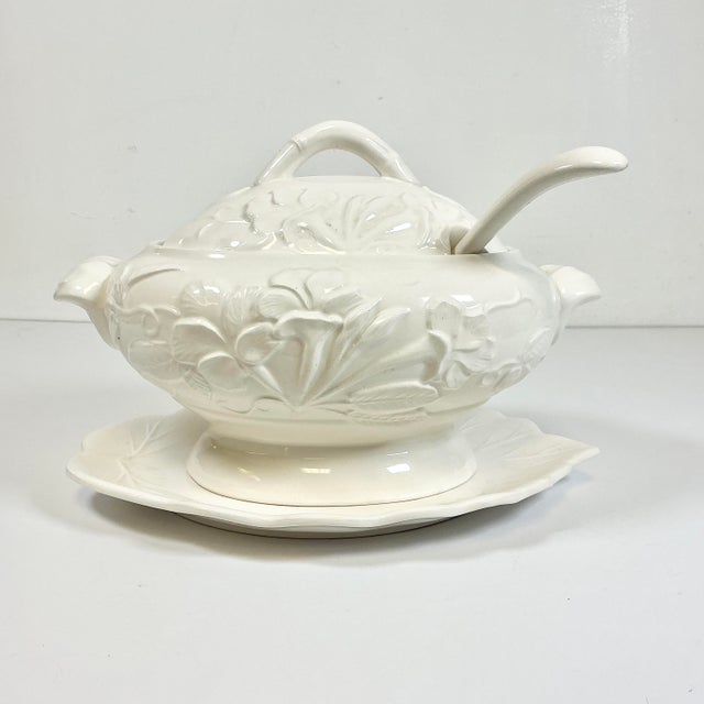 This is a lovely Cream ware ironstone Soup Tureen. It features a raise flora design of blooming Iris and leaves. The set...