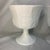 These are vintage white milk glass pedestal bowls in the "Harvest Grape" or "Colony" pattern by Indiana Glass Company....