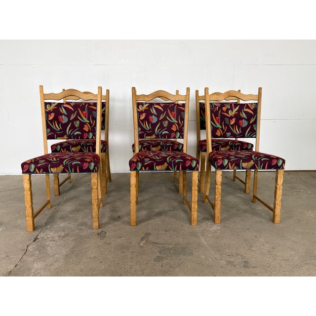 This set of six dining chairs is constructed in solid oak and was produced in Denmark, likely during the 1960s or 1970s....