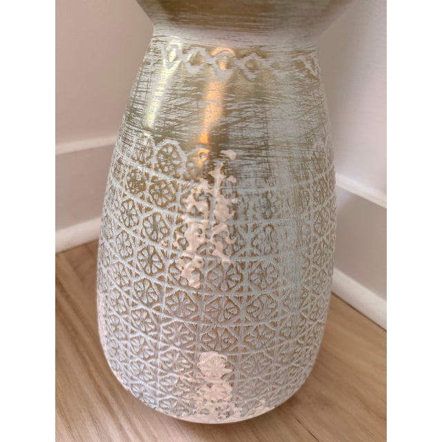 A beautifully textured ceramic vase finished in a soft robin’s egg blue glaze with intentional whitewashed and brushed...