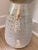 A beautifully textured ceramic vase finished in a soft robin’s egg blue glaze with intentional whitewashed and brushed...