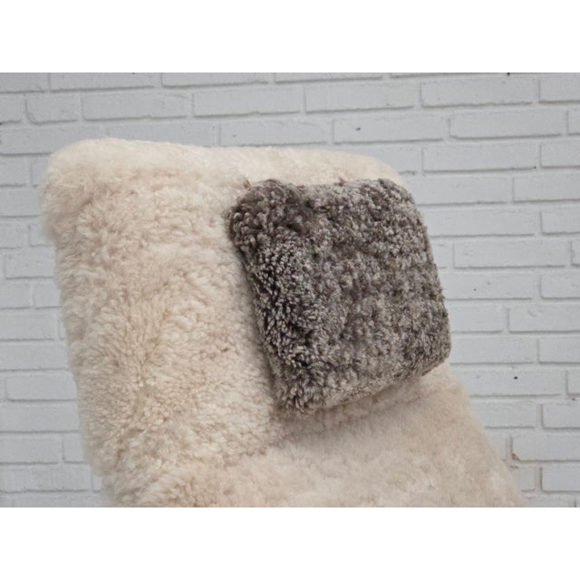 1970s, Danish rocking chair. Totally renovated - reupholstered in quality genuine sheepskin "Canberra" and "Wellington"....