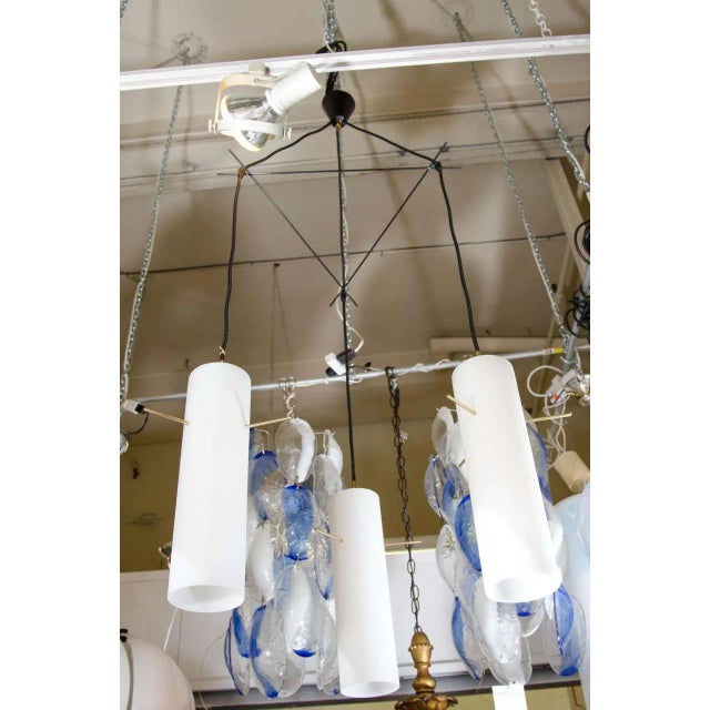 An elegant Italian 1950s modern chandelier attributed to the famed lighting house Stilnovo. The three case glass tubes of...