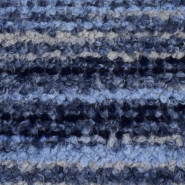 A fun, offbeat play on boucl√© that goes beyond the typical solid or m√©lange. This fabric stands out for its irregular...
