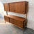 A substantial Danish two-piece highboard from the 1960s, combining warm teak casework with a lighter oak support structure...
