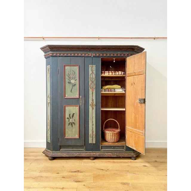 An absolutely stunning hand painted 19th C Austrian armoire. Beautiful floral designs in panels, each unique. It is a...