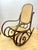 Authentic bentwood rocker with hand caned seat and back. Dark stained wood. Made in Poland, indicating Thonet produced