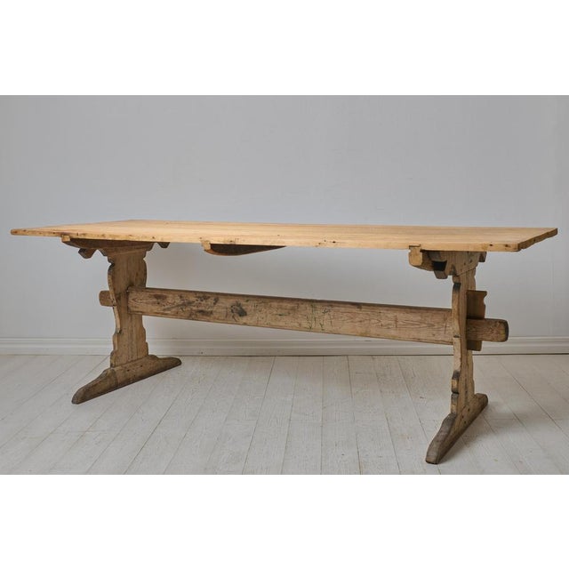 Large antique dining table, a so called trestle table, from the early 1800s. The table is made in solid pine in northern...