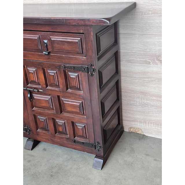 From Northern Spain, constructed of solid walnut, the rectangular top with molded edge atop a conforming case housing...