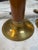 Elegant pair of mid-century modern table lamps featuring warm brass construction accented with rich brown lacquered...