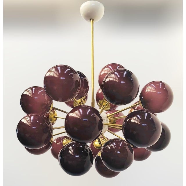 Italian oval shaped sputnik chandelier with 24 frosted amethyst Murano glass globes mounted on brass frame in unlacquered...
