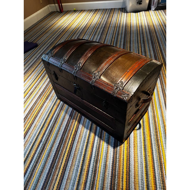 Wooden construction wrapped with some form of thin metal (tin?) and also wooden accents. Pull out tray. Was purchased from...