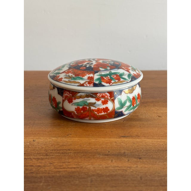 Beautiful covered round trinket dish with a traditional-colored Japanese Imari transfer pattern. Marked on bottom. Most...