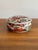 Beautiful covered round trinket dish with a traditional-colored Japanese Imari transfer pattern. Marked on bottom. Most...