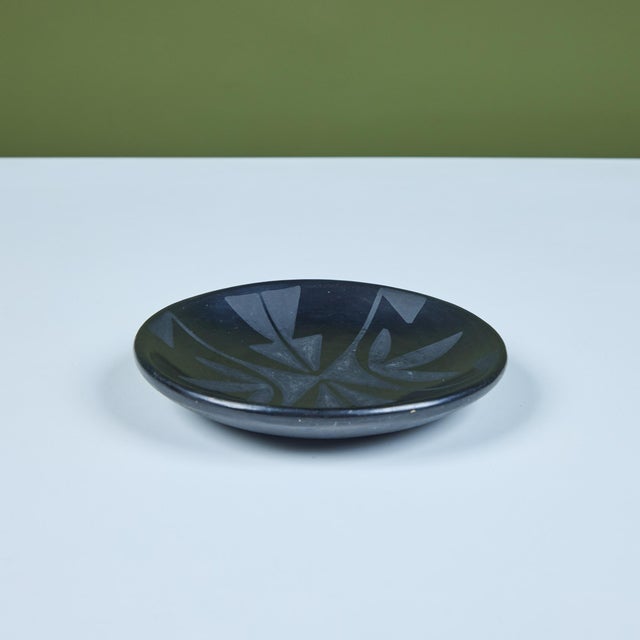 Ceramic dish by Native American pottery artist Maria Martinez and Santana c.1960s. The round plate features a black-on-...