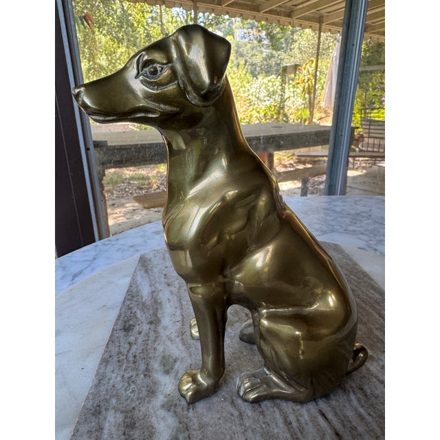 Midcentury solid brass sitting dog figurine. Smooth polished surface and realistic sculpted details. Ready to display on a...
