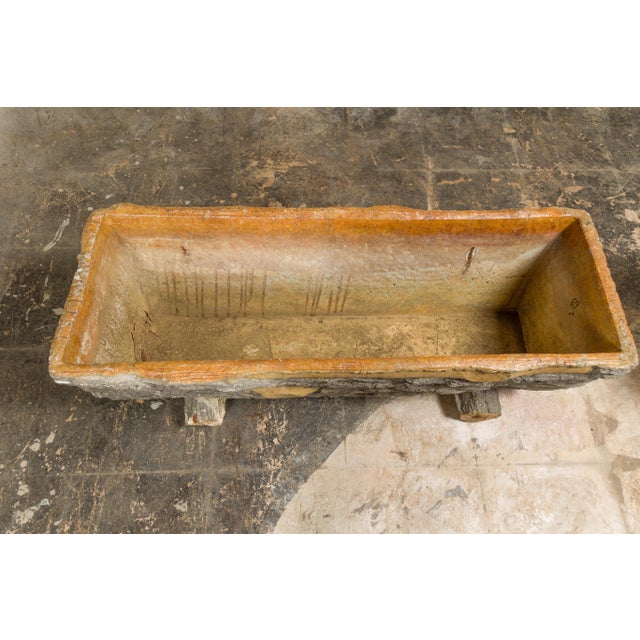 A pair of faux-bois trough shaped planters circa 1930, made of concrete with grey and orange tones. Enhance your outdoor...