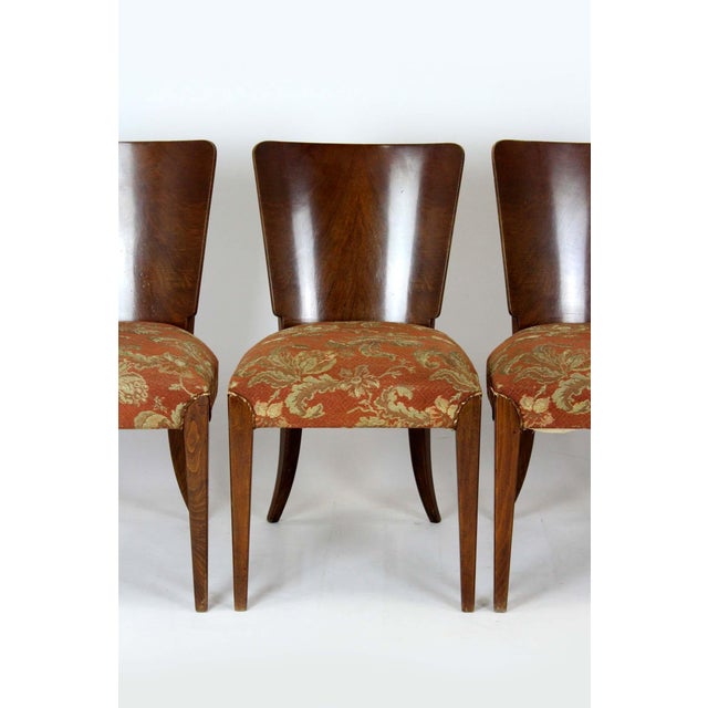 Set of four walnut dining chairs, mod. H-214, designed by Jindrich Halabala for Up Zavody. Manufactured in the 1950s in...