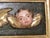 Antique Spanish Colonial hand carved wood panel with the heads of three winged putti or cherubs in high relief, c.1900 The...