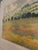 Limited-edition mid-to-late 20th-century landscape print. Features a colorful pastoral field of poppies and rolling hills...