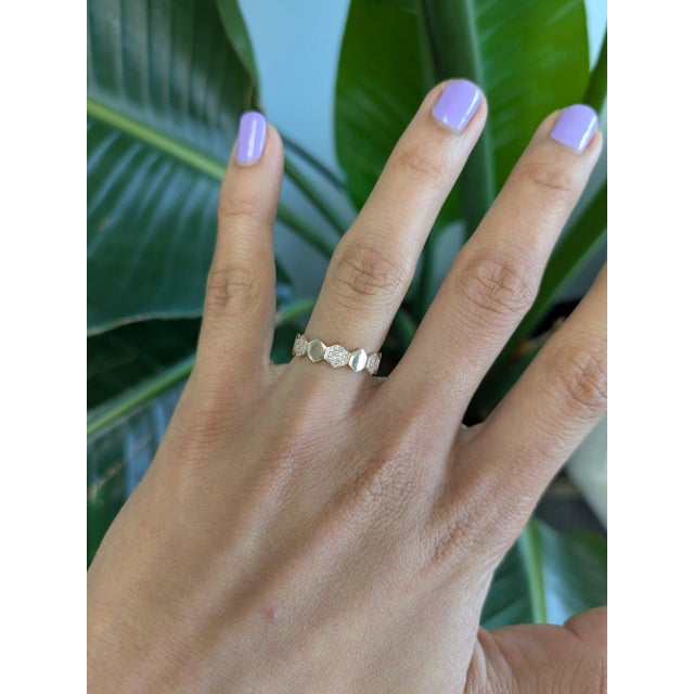 Forty-two earth-mined diamonds sparkle across this solid 14K yellow gold band, totalling 0.11 carats. Warm and brilliant,...