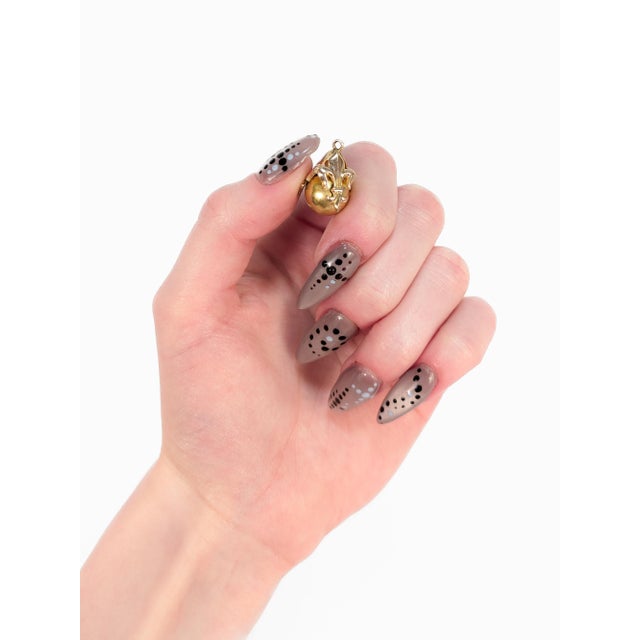 A fine antique Victorian charm. With a gold plated body. In the form of a sphere with 3 applied Fleur-de-Lis devices. With...