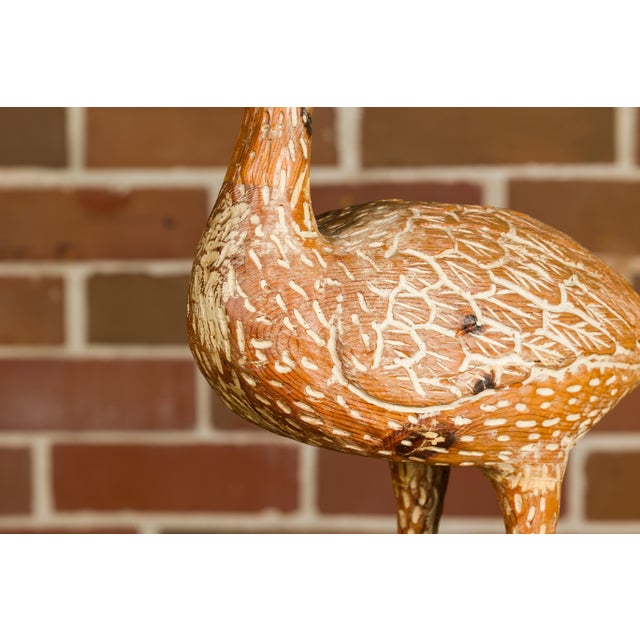 An Italian carved wooden duck sculpture from circa 1920 with light painted accents and textured base. Enhance your living...