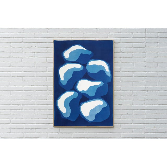 “Pile of Stones” is an original handmade cyanotype monotype that distills the quiet presence of stacked forms into a...