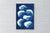 “Pile of Stones” is an original handmade cyanotype monotype that distills the quiet presence of stacked forms into a...