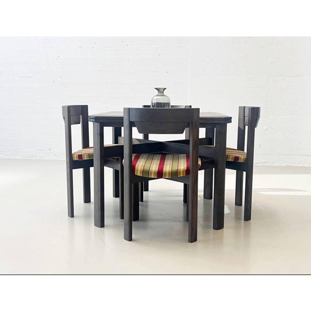 This set consists of a fold-out dining table and four chairs from the swiss manufacturer girsberger, a renowned furniture...