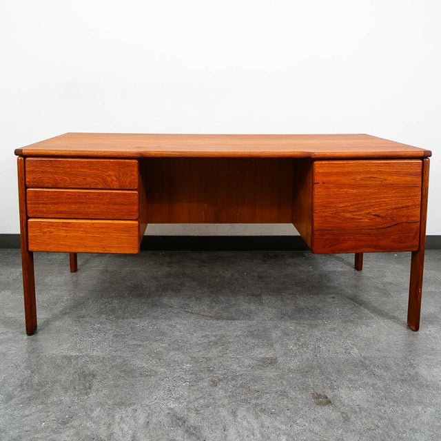 Large Danish executive desk in teak. This desk features 4 drawers and shelving along the back. Restored and ready for...