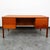 Large Danish executive desk in teak. This desk features 4 drawers and shelving along the back. Restored and ready for...