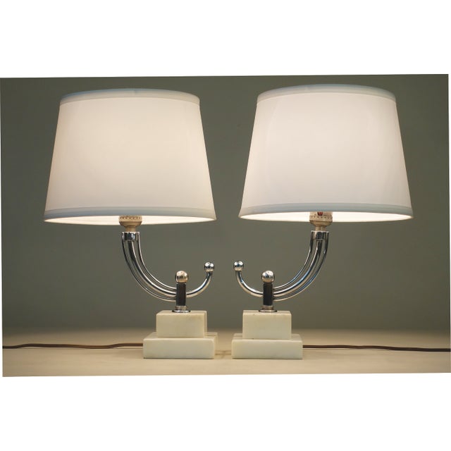 A brilliant and striking pair of sleek Streamline Art Deco styled stacked Marble polished Chrome candelabra style table...