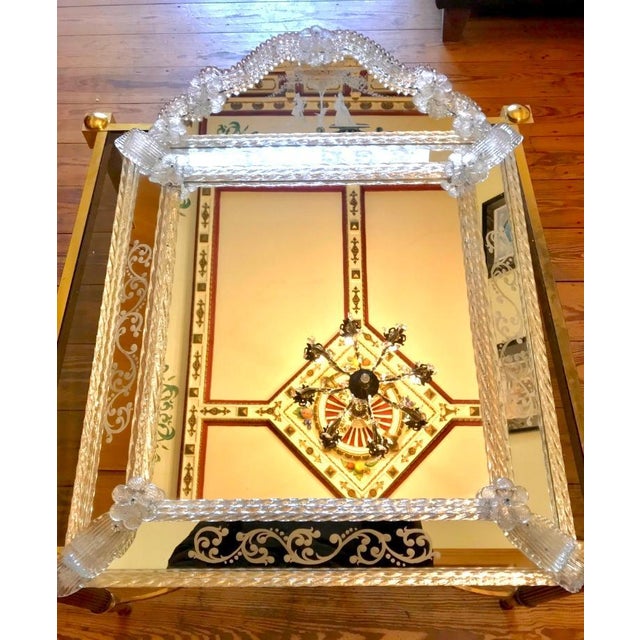 Ornaments from the 1920s. The beveled mirror frame features finely crafted floral glass ornaments and rosettes. True...