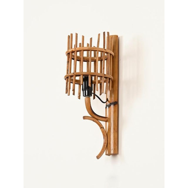 Wonderful pair of mid-century lantern-style sconces in rattan and bamboo. These stylish organic lights are attributed to...