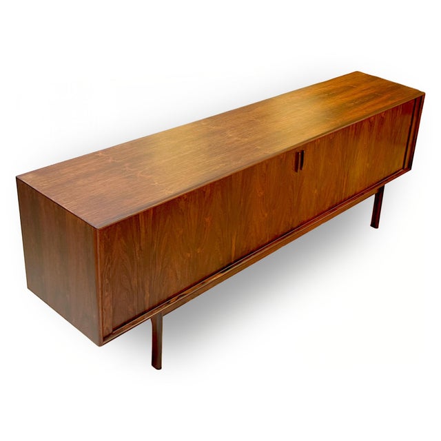 An exceptional example of 1960s Danish Modern design, this rosewood credenza by Henning Kjaernulf for Bruno Hansen...
