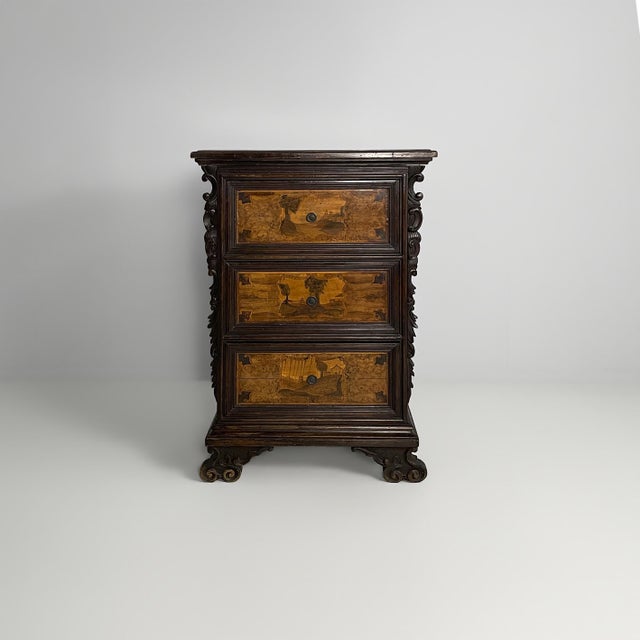 Italian wooden bedside table, 1800s Bergamo bedside table in dark wood, with three front drawers decorated with light wood...