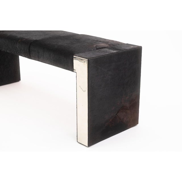 A Bernhardt hide and chrome accent bench. This wonderful modern accent bench features a very chic, very unique set of...
