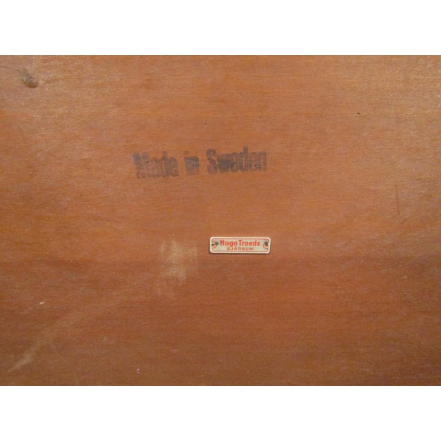 Mid-century Danish coffee table by Hugo Troeds. This table features a sleek modern design with an eye catching teak top...