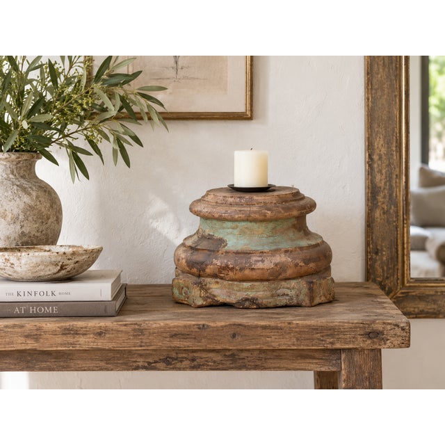 The front is a study in layers. Moldings stack one above the other, a band of scrolls and leaves sits at the center and a...