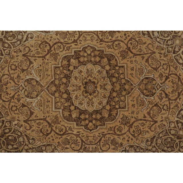 Hand-knotted in wool, this 4x6 Antique Persian Tabriz rug, circa 1900–1919, features an ornate floral medallion, scrolling...