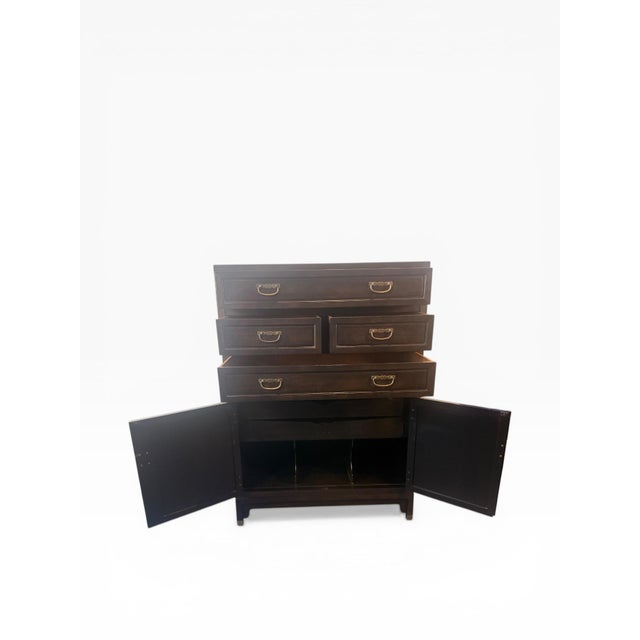 A refined and architecturally composed gentleman’s chest designed by Michael Taylor for Baker Furniture, showcasing the...