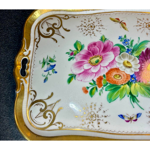 Hand painted porcelain serving tray featuring a central floral bouquet in vibrant colors of pink, orange, and blue with...