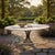 A "Sheif of Wheat" shaped heavy pedestal iron table base is sold here with a 60" round honed travertine top ideal as a...