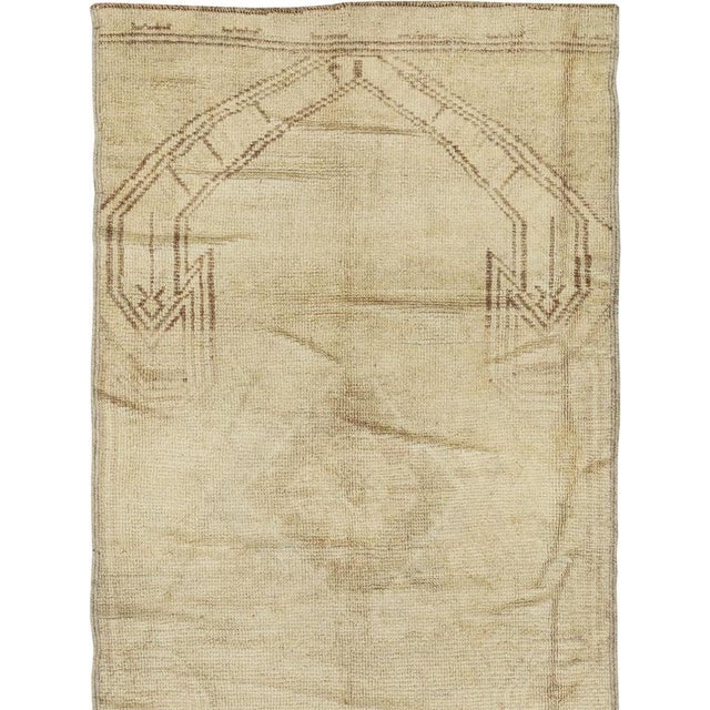 This mid-20th-century Turkish Anatolian runner presents an understated composition in pale sand, warm ivory, muted beige,...