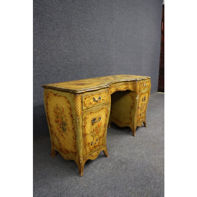 Italian paint-decorated vanity featuring a shaped top with floral bouquets, scrolling rococo ornament, and a mustard-...